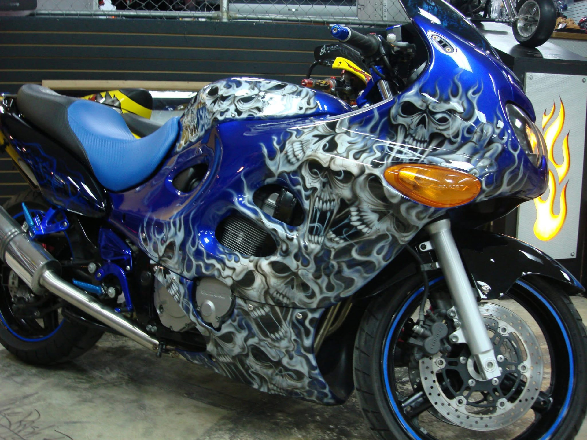 Blue sport motorcycle airbrushed with skulls and ghost flames